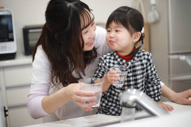 istock Parents and children drinking tap water 1291761546