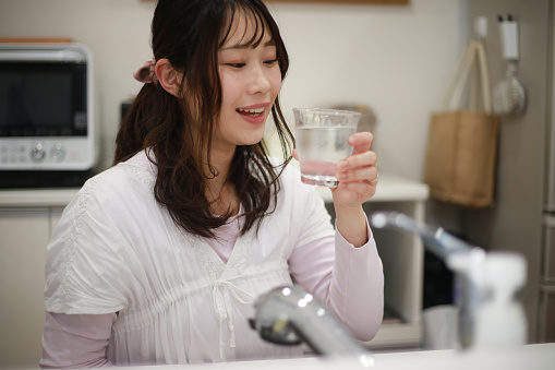 Woman drinking tap water