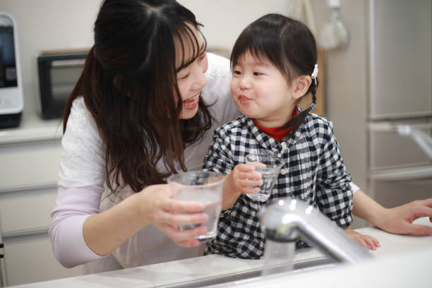 istock Parents and children drinking tap water 1291761636