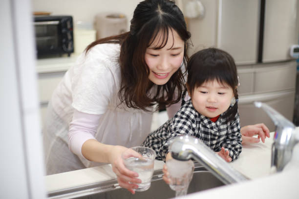 istock Parents and children drinking tap water 1291761642