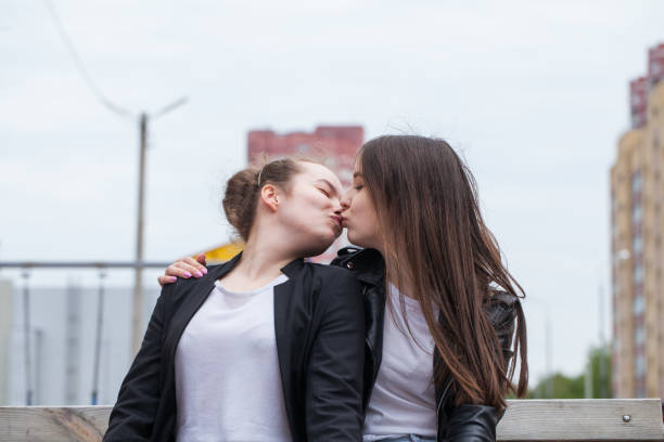 istock two young women kiss 1291763733