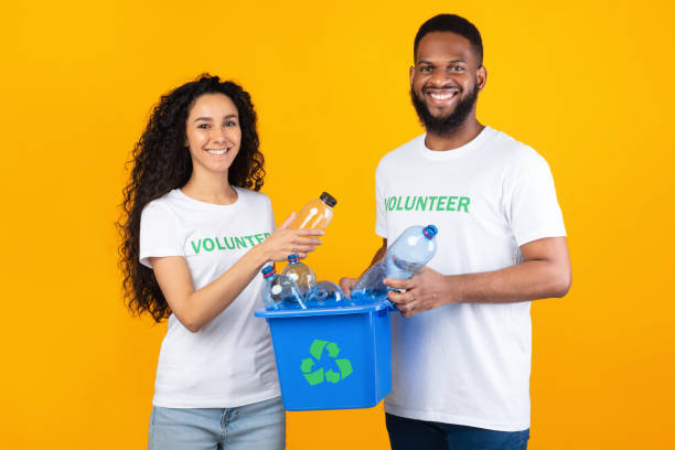 istock Volunteers Holding Box With Recycle Symbol And Plastic Bottles, Studio 1291764288