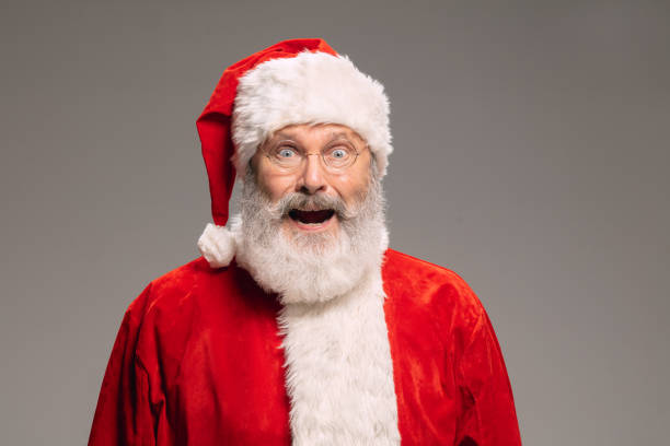 istock Senior man like Santa Claus isolated on grey studio background 1291764361