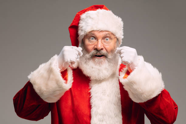 istock Senior man like Santa Claus isolated on grey studio background 1291764365
