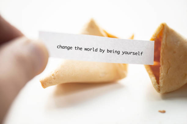 change the world by being yourself - believe aspirations forecasting fortune cookie imagens e fotografias de stock