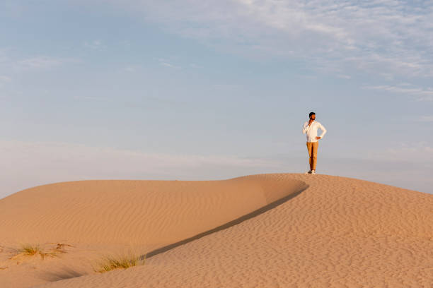 istock a man in a desert at surise 1291765631