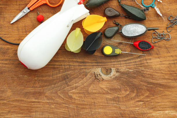 istock Fishing gear on wooden background close up 1291765733