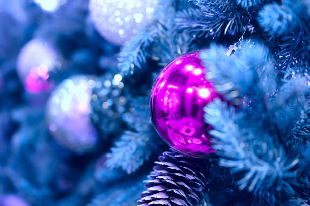 istock Christmas background with a pink ball that hangs on the tree 1291767992
