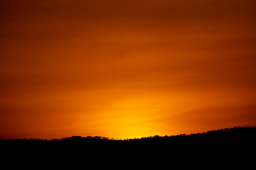 Dark hills on sunset sky background