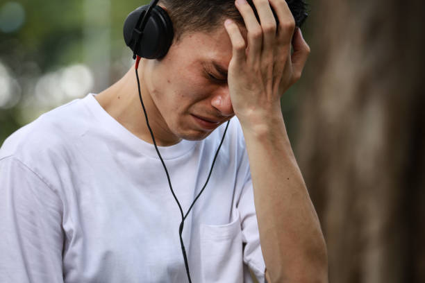 istock A man listening to music while crying 1291768505