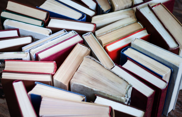 istock stack of old book, education concept background, many books piles with copy space for text 1291768667