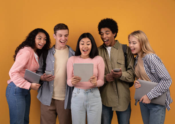 istock Modern gadgets, social networks and education. Shocked cheerful young multi ethnic students looking in digital tablet 1291770004