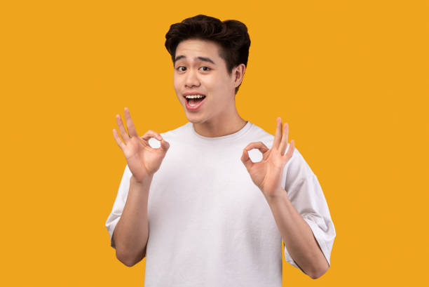 istock Happy asian young man gesturing okay and smiling 1291771019