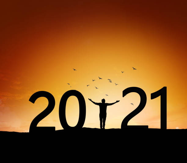 istock 2021, silhouette of a successful man standing at hill raising hands 1291771192