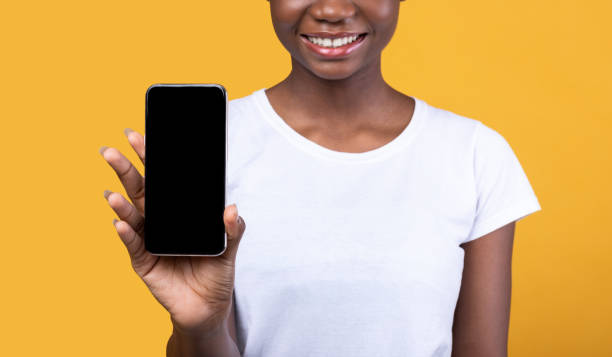istock Unrecognizable Black Woman Showing Mobile Phone Screen Over Yellow Background 1291771780