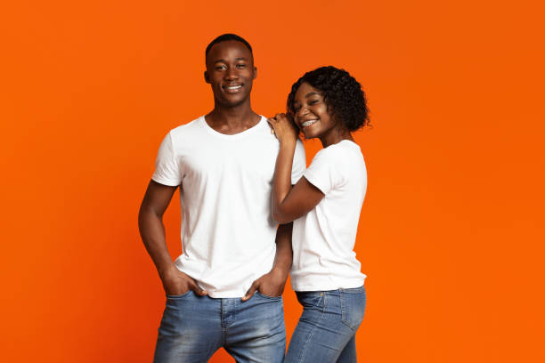 istock Loving black couple posing together on orange 1291772850
