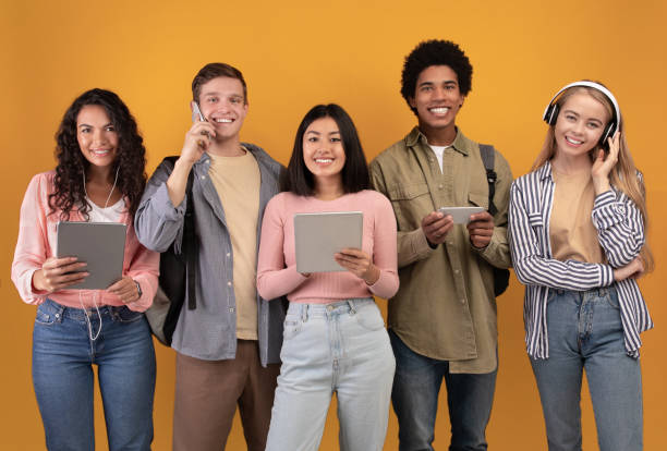 istock Modern devices, lifestyle and students abroad. Smiling young multiracial people with modern devices 1291773040