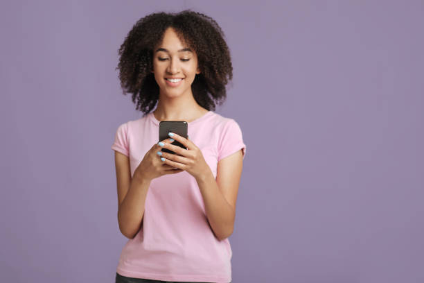 istock Texting message and modern blog. Smiling lady holding smartphone 1291774138