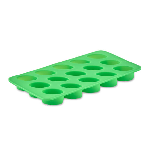 istock Green silicone form isolated on white background. Candy cup, silicone mold, bakeware. 1291774425
