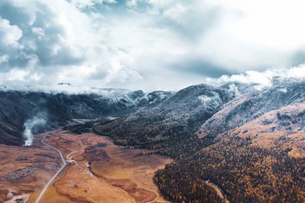 istock First snow and clouds on mountains in beautiful autumn valley 1291774677