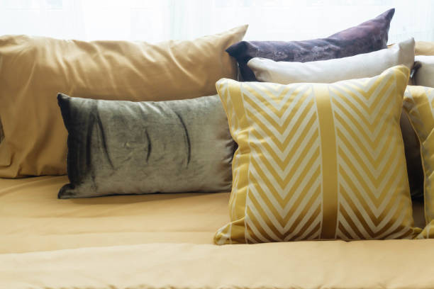 istock Various colorful pillows on the bed, nobody. 1291775098