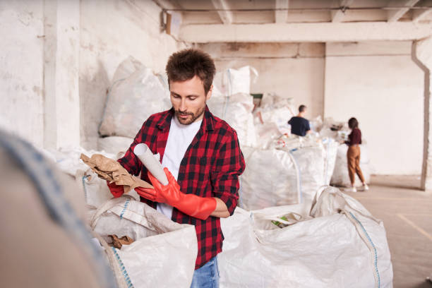 istock Man looking at the paper and cardboard wastes 1291778002