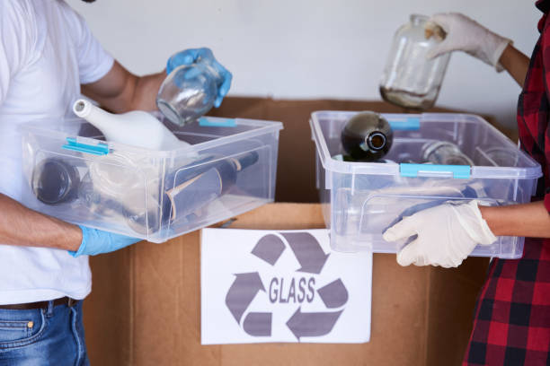 istock Couple throwing out wastes at the garbage sorting factory 1291778045