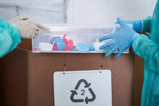 istock People separating plastic caps at the waste sorting plant 1291778071