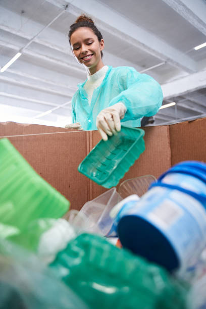 istock Woman throwing plastic wastes 1291778079