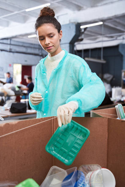 istock Woman putting plastic wastes at the sorting box 1291778086
