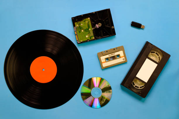 istock A collection of old and modern storage devices technology, Gramophone record videocassette audiocassette tape compact disk hard disk and flash drive 1291783102