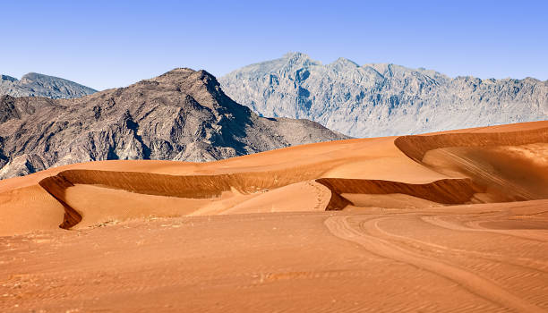 Sand dunes and Rocky hills Sand dunes and rock in the Hatta desert fujairah stock pictures, royalty-free photos & images