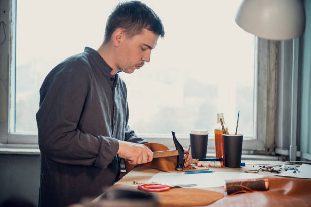 istock In a shoe workshop, a tanner makes handmade shoes using a hammer and other tools 1291783552