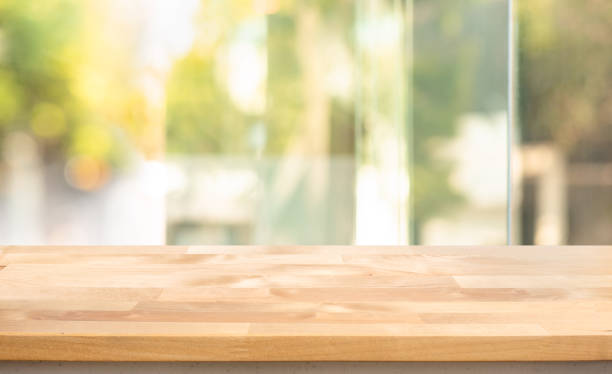 istock Empty wood table top on blur abstract  window glass view. 1291784477