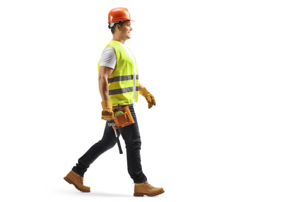 istock Full length profile shot of a construction worker with a helmet and tool belt walking 1291786704