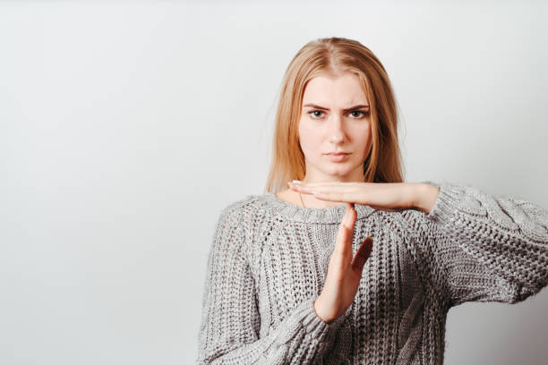 istock Confident woman showing T sign with hands 1291788935