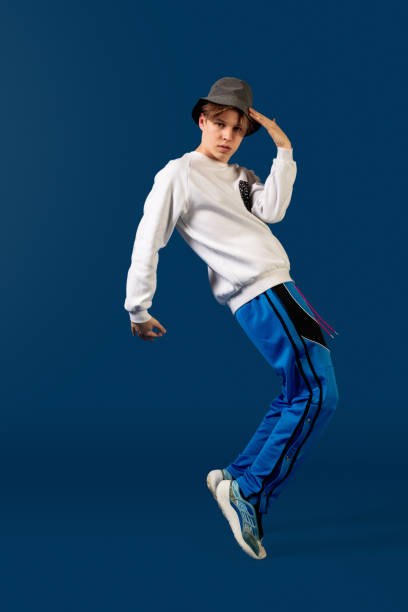 istock Old-school fashioned young man dancing isolated on blue background 1291789246