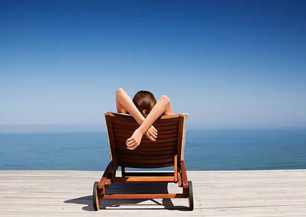 Photo of Rear view of woman on deck chair