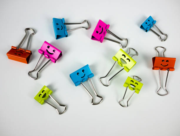 istock Several fun paper clips. Stationery pins smiling 1291790234
