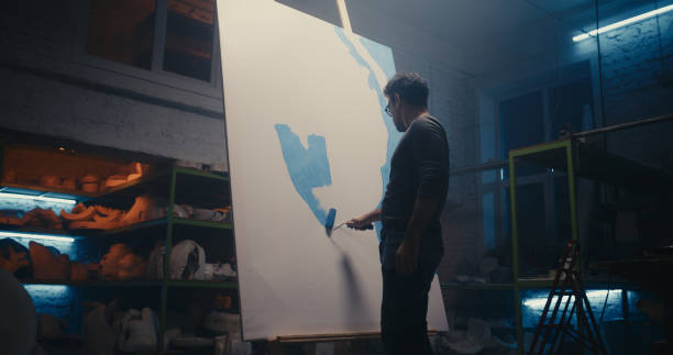 istock Modern artist painting in workshop 1291790510