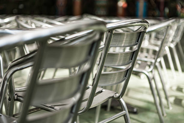 Abstract aluminium  chairs and tables in outdroor cafe and resturant. Soft focus for selective focus. Close up, copy space.
