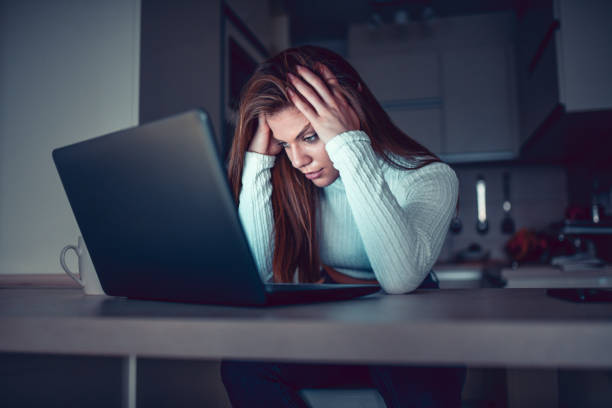 istock Beautiful Female Focused On Laptop Work In Kitchen 1291791725