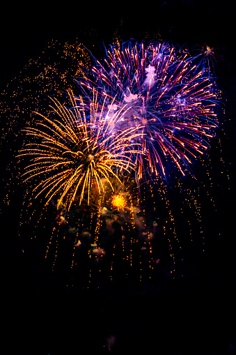 Holiday Fireworks at New Year Eve. Abstract Festive background with fireworks sparkles. Copyspace