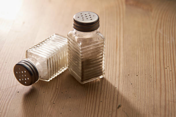 salt and pepper shaker on the wooden table top salt and pepper shaker on the wooden table top salt pepper ingredient black peppercorn stock pictures, royalty-free photos & images