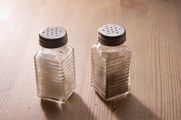 salt and pepper shaker on the wooden table top salt and pepper shaker on the wooden table top salt pepper ingredient black peppercorn stock pictures, royalty-free photos & images