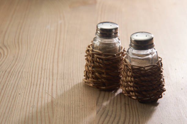 salt and pepper shaker on the wooden table top salt and pepper shaker on the wooden table top salt pepper ingredient black peppercorn stock pictures, royalty-free photos & images