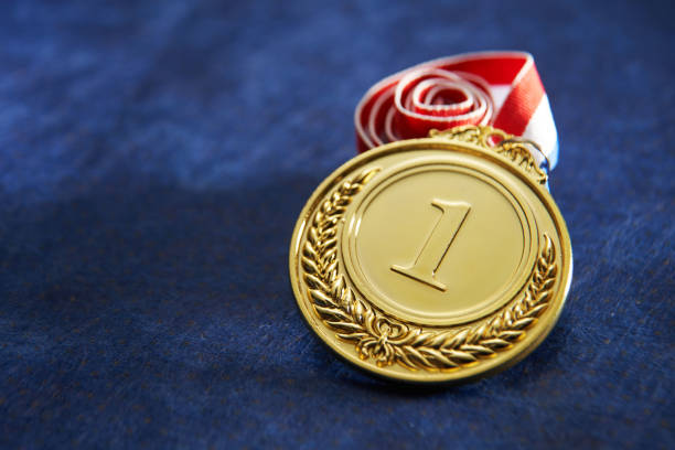 gold medal gold medal with ribbon on blue background record breaking stock pictures, royalty-free photos & images