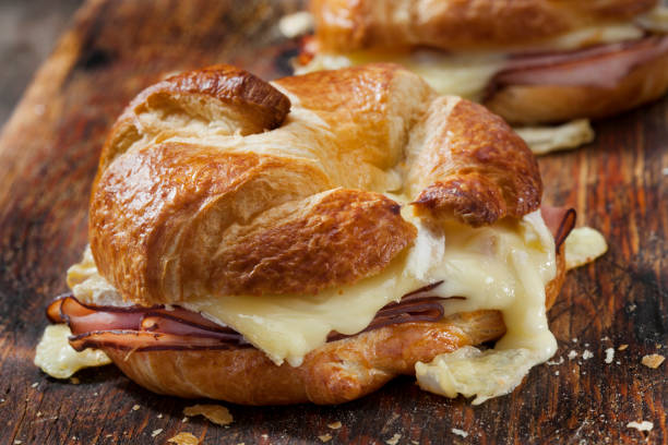 panini croissant al prosciutto al forno e brie con senape di digione - cheese sandwich foto e immagini stock