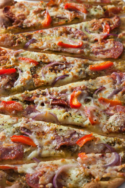 Basil Pesto Flat Bread Pizza with Prosciutto, Salami, Pepperoni, Red Peppers and Spanish Onions