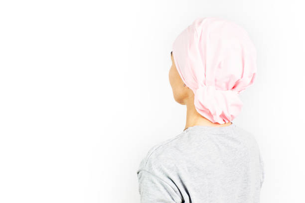 Woman with a pink headscarf for cancer. stock photo